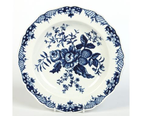 A Worcester scalloped plate. Printed in underglaze blue with the pinecone pattern. Crescent mark 1770, 20.35cm wide.  Conditi
