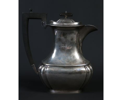 A George V silver hot water jug with ebonized handle and finial by Viners Ltd. Assayed Sheffield 1937, 780 grams gross, 21cm.