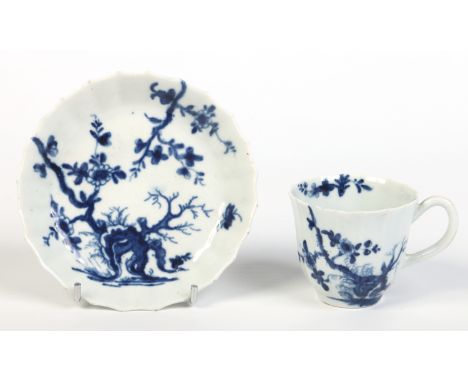 A Worcester faceted coffee cup and saucer with grooved loop handle. Painted in underglaze blue with the Prunus Root pattern. 