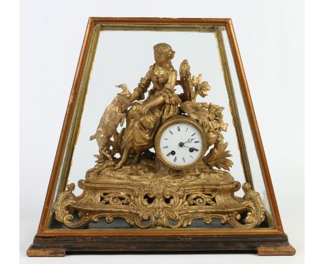 A cased 19th century French gilt metal mantel clock. Surmounted with the figure of a shepherdess and goat and raised on a roc