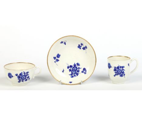 A Worcester trio with gilt dentil rims and painted in wet blue with scattered sprigs. Underglaze crossed swords and number 9,
