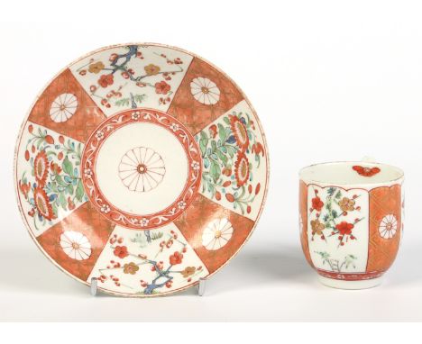 A Worcester coffee cup and saucer with grooved loop handle. Painted in the Kakiemon palette with prunus blossom and chrysanth