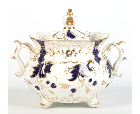 A Rockingham sucrier and cover with crown moulded finial. Painted in cobalt blue and gilt with trailing leaves. Pattern 1253,