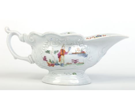 A Worcester silver shaped sauceboat. Crisply moulded with cartouches of trailing leaves and a cherub mask and finely enamelle