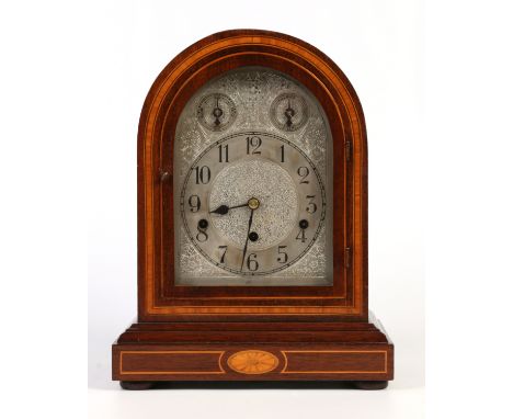 An early 20th German mahogany cased dome top bracket clock. With silvered arch top dial having two subsidiaries for slow / fa