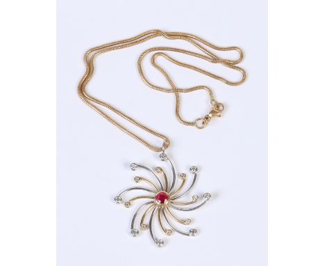 An 18 carat white and yellow gold starburst pendant set with a ruby and sixteen diamonds and supported on an associated 18 ca