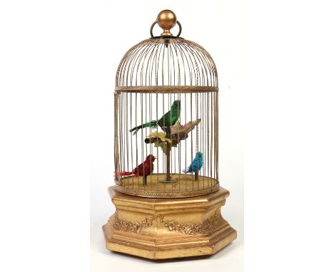 An early 20th century French triple singing bird cage clockwork automaton. With a domed gilt wirework cage housing the three 