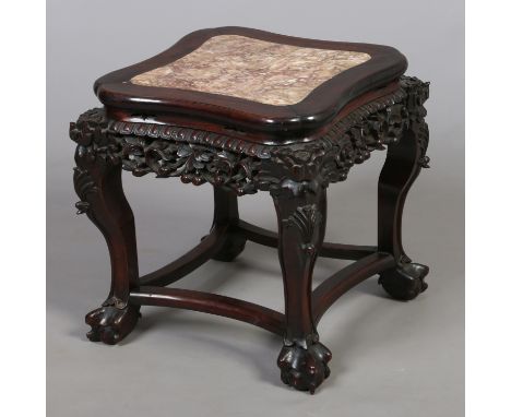 A 19th century Chinese carved hardwood marble top plant stand. With shaped square top, pierced frieze and raised on scroll su