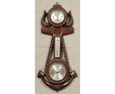 A carved oak wall clock / barometer of nautical theme formed as a fouled anchor and a pair of dolphins. With silvered dials a