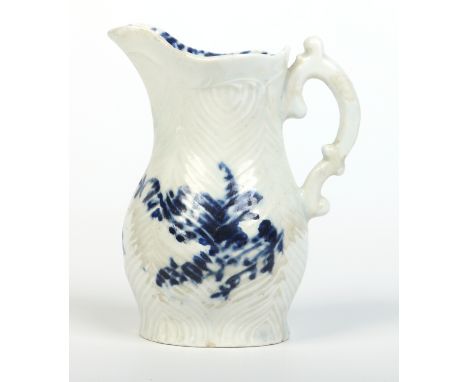 A Worcester feather moulded cream jug with double scrolling handle. Painted in underglaze blue with the Feather Mould Floral 