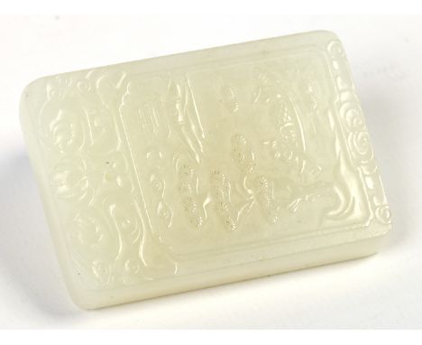 A Chinese celadon jade tablet / pendant. Carved with an island scene with a building, figures in a boat and a pine tree, with