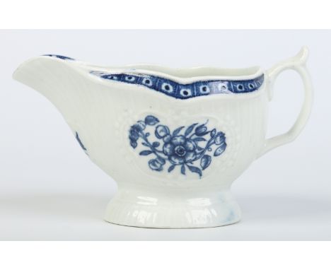 A Worcester moulded sauceboat. Painted in underglaze blue with the Strap Flute Sauceboat Floral design. Crescent mark c1770, 