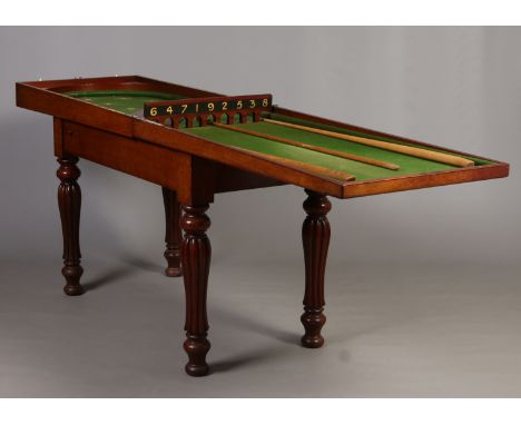 A Victorian mahogany bagatelle table raised on reeded baluster supports and with cues, 122cm long closed. 