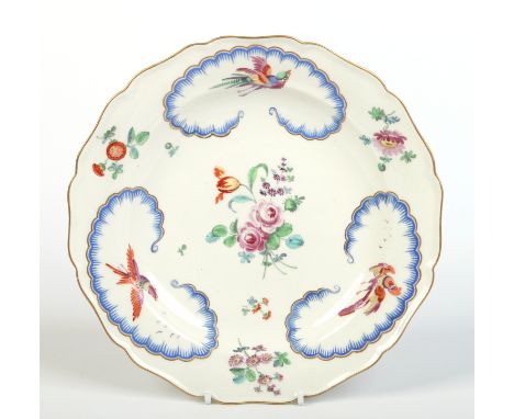 A Worcester Sevres style scalloped plate decorated in the atelier of James Giles. Depicting colourful birds in blue feathered