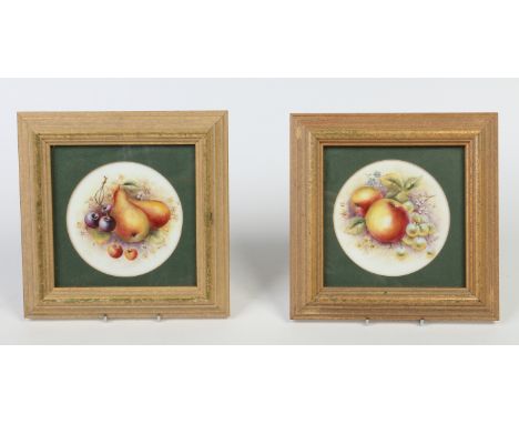 A pair of gilt framed bone china plaques in the Royal Worcester style painted by Bryan Cox with fruit, 12cm diameter.  Condit