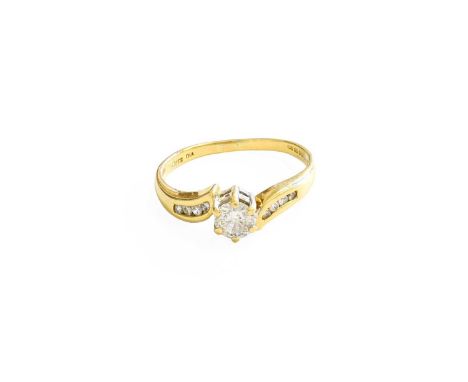 An 18 Carat Gold Diamond Solitaire Ring, the round brilliant cut diamond in a yellow claw setting, to diamond set twist shoul