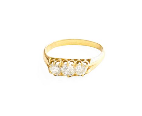 A Diamond Three Stone Ring, the old cut diamonds in yellow claw settings, to a plain polished shank, total estimated diamond 