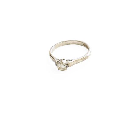 An 18 Carat White Gold Diamond Solitaire Ring, the round brilliant cut diamond in a claw setting, to a tapered shoulder plain