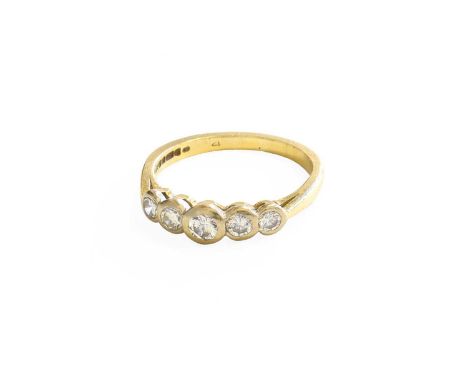 An 18 Carat Gold Diamond Five Stone Ring, the graduated round brilliant cut diamonds, in white rubbed over settings, to a yel