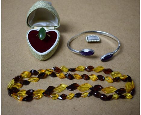 A 9ct gold jade dress ring; a mourning brooch, set with seed pearls; a silver and amethyst torque; an amber coloured necklace