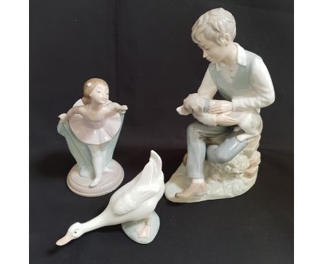 THREE NAO FIGURESincluding Ballerina, 18cm high; Boy with dog, 26cm high; and a Goose, 11cm high (3) 