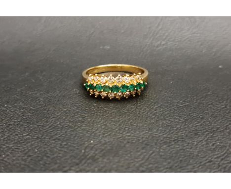 EMERALD AND DIAMOND RINGthe central row of nine graduated emeralds with a row of diamonds above and below, on nine carat gold