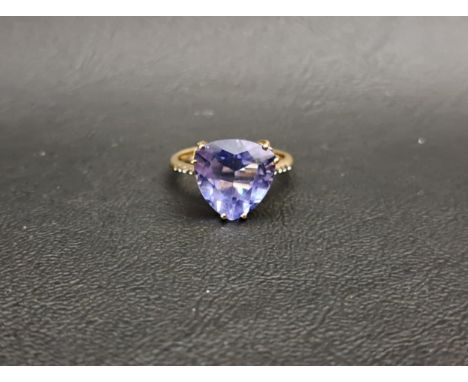 IMPRESSIVE TANZANITE SINGLE STONE RINGthe trillion cut tanzanite measuring approximately 11.6mm x 11.7mm x 7mm, on nine carat