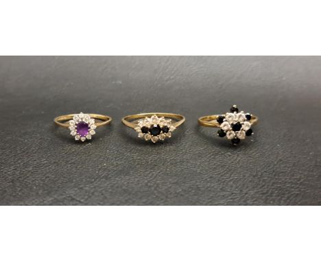 THREE GEM AND CZ CLUSTER RINGSone a sapphire and CZ cluster, another with three central sapphires in CZ surround, and the oth