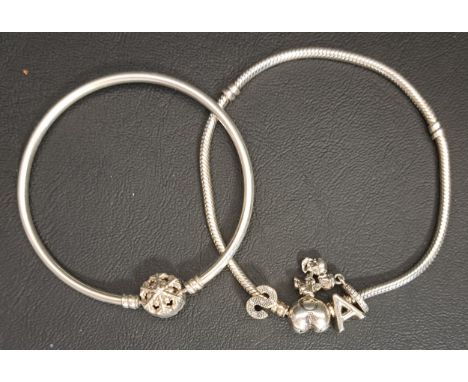 PANDORA SILVER HEART CLASP MOMENTS CHARM BRACELETwith three charms; together with a Pandora silver Sparkling Snowflake clasp 