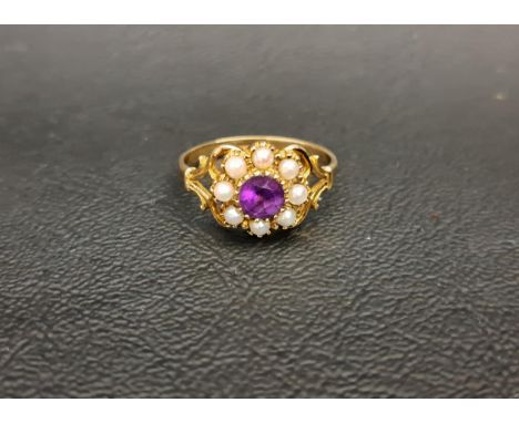 PRETTY AMETHYST AND PEARL CLUSTER RINGthe central round cut amethyst in pearl surround, on nine carat gold shank with pierced