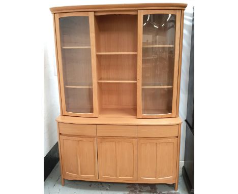 NATHAN LIGHT OAK ILLUMINATED SIDE CABINETthe upper section with two glazed doors flanking open shelves, above three drawers a