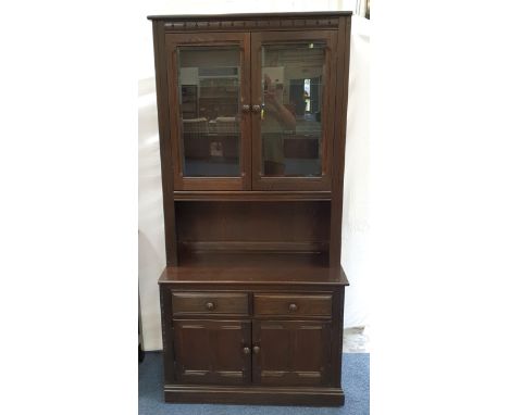 ERCOL ELM MURAL OLD COLONIAL GLAZED BOOKCASE/DISPLAY CABINETthe two door glazed unit with two glass shelves over two drawer a
