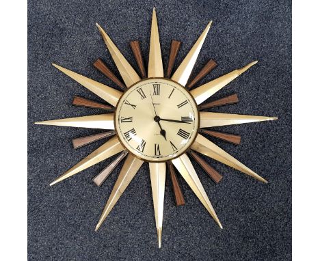 VINTAGE METAMEC STARBURST WALL CLOCK Central circular dial with faceted hands with pointed brass and two tone faux wood frame