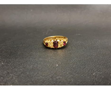 RUBY AND DIAMOND RINGthe graduated oval cut rubies separated by small diamonds, on eighteen carat gold shank, ring size M and