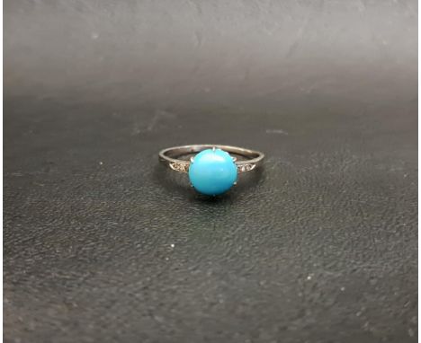TURQUOISE AND DIAMOND RINGthe central round cabochon turquoise flanked by diamond set shoulders, on unmarked platinum shank, 