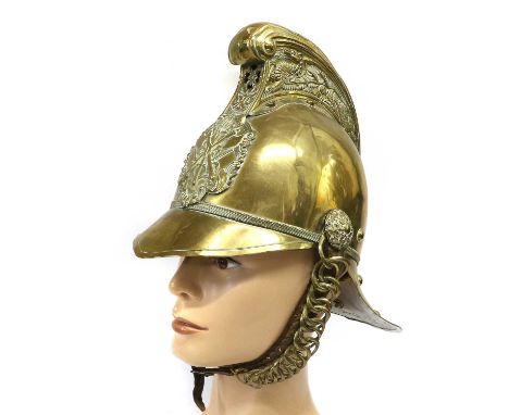 A Late 19th/Early 20th Century Brass Fireman's Helmet, the high comb with dragon decoration, with crossed axe and hose badge 