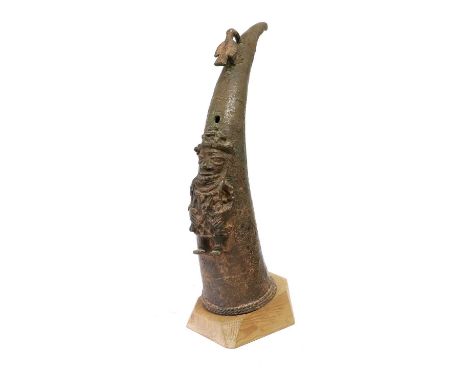 An Early Benin Lost Wax Cast Bronze Altar Tusk Mount, Nigeria, in the form of a tusk with figure of a bird over a sound hole,