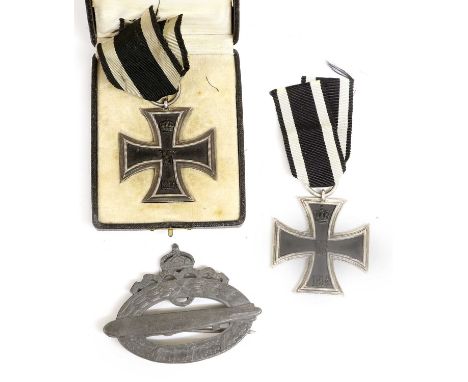 A First World War German Iron Cross, second class, the suspender ring stamped R-W in case of issue; another Example, uncased;
