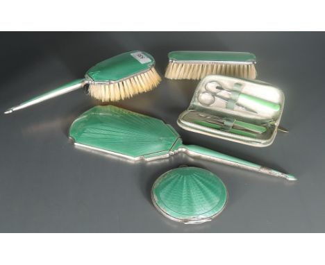 A George VI guilloche enamelled silver backed three-piece dressing table set, comprising hand mirror, clothes and hair brush,