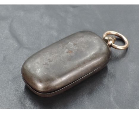 A white and yellow metal sovereign holder, of rounded and hinged rectangular form with ring suspension and button release, un