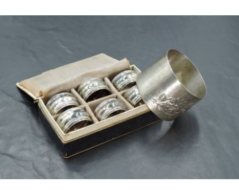 A boxed set of six small German white metal napkin rings, of circular moulded form with engraved initials MS, German 800 stan