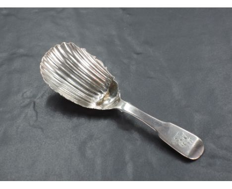 An early 19th century Irish Silver caddy spoon, fiddle pattern with shaped and fluted oval bowl, engraved initials to termina