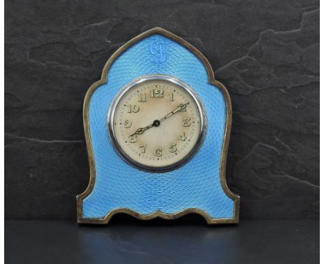 A George V silver &amp; guilloche enamel clock, of shaped lancet form with blue enamelled engine turned decoration and initia