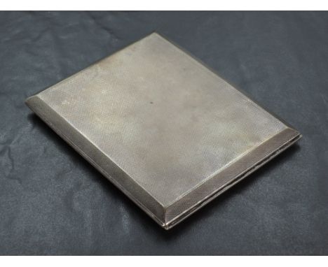 A 1930's silver cigarette case, of hinged rectangular form with engine-turned surface and chamfered edges, marks for London 1