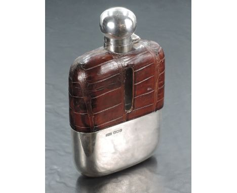 A George V Silver, leather and glass hip flask, of traditional form with spherical screw-lock hinged cover, crocodile skin ha