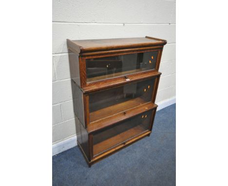 AN EARLY 20TH CENTURY OAK GLOBE-WERNICKE CO LTD, LONDON, THREE SECTION BOOKCASE, with glass fall front doors, width 87cm x de