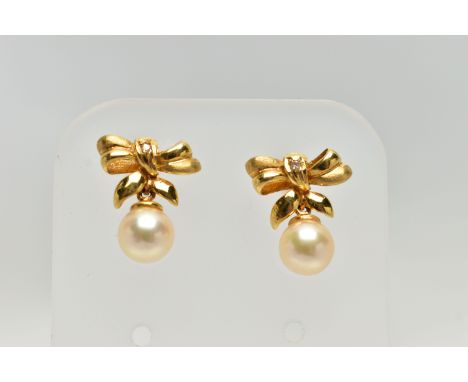 A PAIR OF 18CT GOLD, CULTURED PEARL DROP EARRINGS, each earring designed as a bow set with a small round brilliant cut diamon