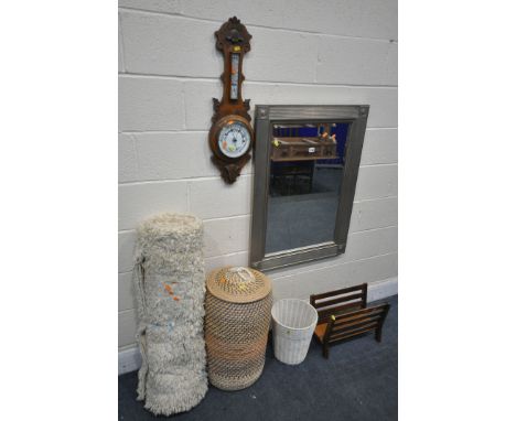 A MODERN SILVER BEVELLED EDGE WALL MIRROR, an Edwardian oak barometer (glass broken) a teak magazine rack, a woollen rug, lin