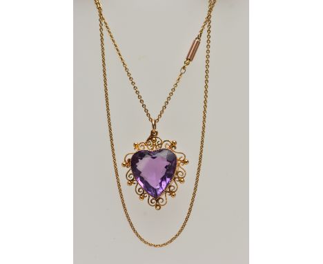 A YELLOW METAL AMETHYST PENDANT NECKLACE, heart cut amethyst, milgrain collet set within a cannetille scroll and bead work su