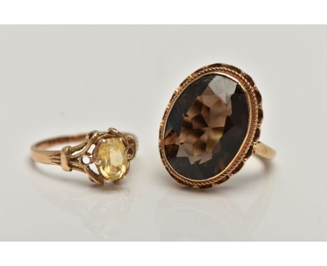 TWO GEMSTONE SET RINGS, the first a large oval smoky quartz, measuring approximately length 18.7mm x width 13.9mm, collet set
